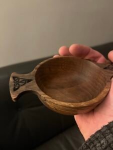 Traditional handcrafted wooden Quaich held in hand